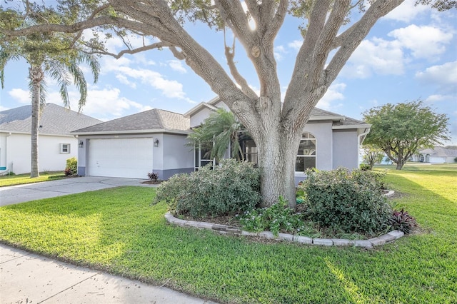 view of front of home with a front yard and a garage