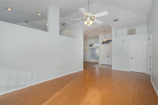 unfurnished living room with high vaulted ceiling, light hardwood / wood-style flooring, and ceiling fan