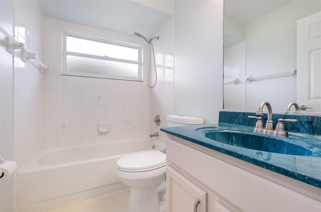 full bathroom featuring toilet, tiled shower / bath combo, and vanity