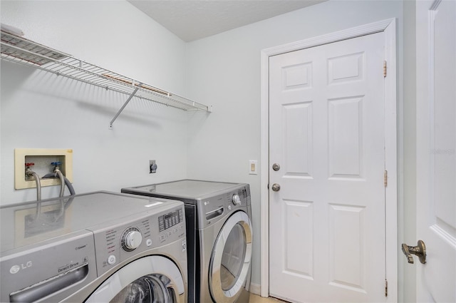 clothes washing area featuring separate washer and dryer