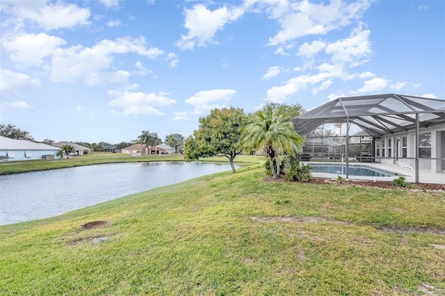 view of yard featuring glass enclosure and a water view