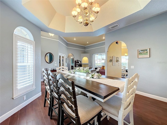 dining space with dark hardwood / wood-style flooring and a notable chandelier