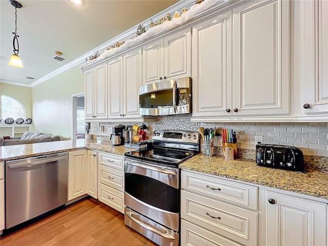 kitchen with backsplash, light hardwood / wood-style floors, pendant lighting, crown molding, and stainless steel appliances