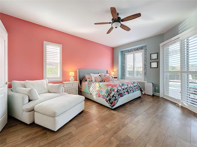 bedroom featuring ceiling fan, access to outside, and light wood-type flooring