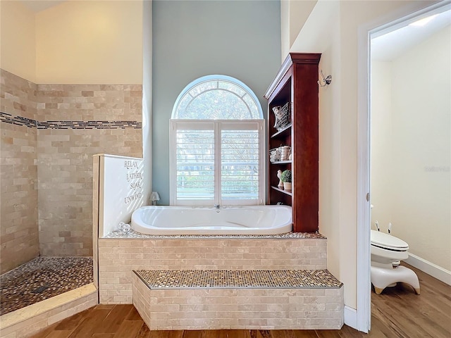 bathroom featuring toilet, independent shower and bath, and hardwood / wood-style floors