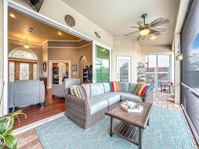 living room featuring ceiling fan and crown molding