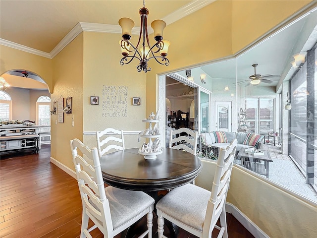 dining room featuring dark hardwood / wood-style flooring, ceiling fan with notable chandelier, and ornamental molding