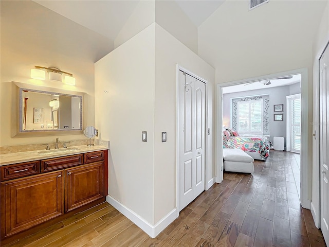 bathroom with lofted ceiling and vanity