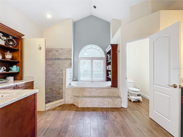 full bathroom with separate shower and tub, vanity, vaulted ceiling, toilet, and wood-type flooring