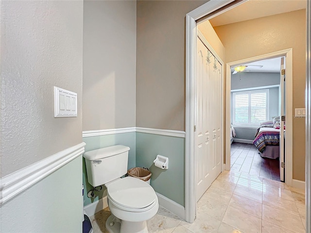 bathroom featuring toilet and ceiling fan