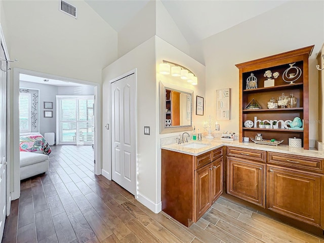 bathroom featuring vanity and vaulted ceiling