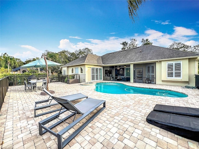 view of pool featuring an in ground hot tub and a patio