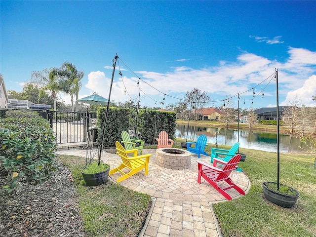 view of patio / terrace with a water view and an outdoor fire pit