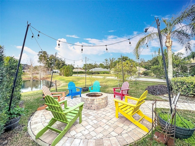 view of patio / terrace with an outdoor fire pit and a water view