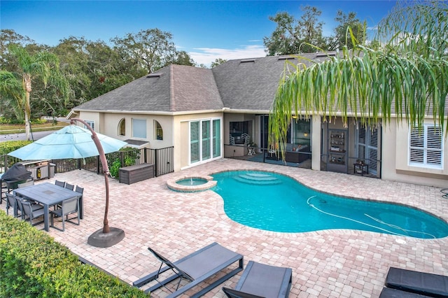 view of swimming pool with a patio area and an in ground hot tub