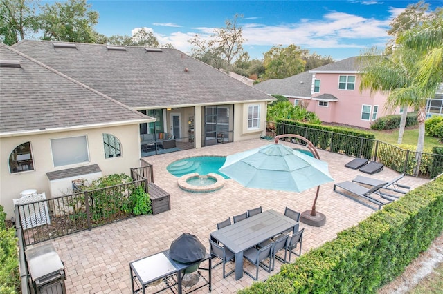 view of swimming pool featuring a patio area and an in ground hot tub