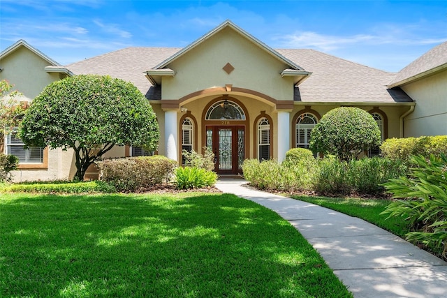 278 Eaglet Way, Lake Mary, FL 32746 - property entrance featuring a yard, stucco siding, and a shingled roof