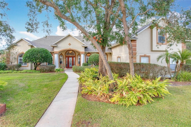 278 Eaglet Way, Lake Mary, FL 32746 - mediterranean / spanish-style house with stucco siding, a front lawn, and french doors
