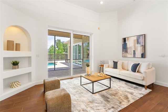 278 Eaglet Way, Lake Mary, FL 32746 - living area featuring wood finished floors, built in features, baseboards, crown molding, and recessed lighting