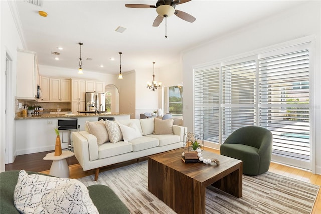 278 Eaglet Way, Lake Mary, FL 32746 - living area with ornamental molding, a chandelier, a ceiling fan, and light wood finished floors