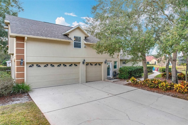 278 Eaglet Way, Lake Mary, FL 32746 - view of front facade featuring a shingled roof, driveway, an attached garage, and stucco siding