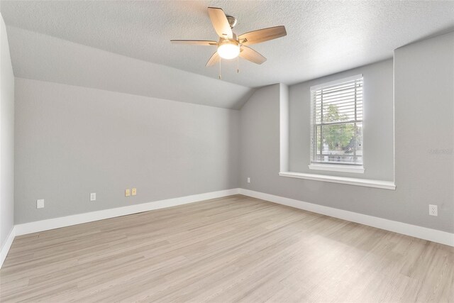 278 Eaglet Way, Lake Mary, FL 32746 - bonus room featuring light wood-type flooring, vaulted ceiling, ceiling fan, baseboards, and a textured ceiling