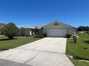 ranch-style house featuring a front lawn and a garage