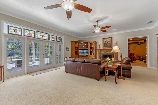 living room with light colored carpet, ornamental molding, french doors, and a textured ceiling