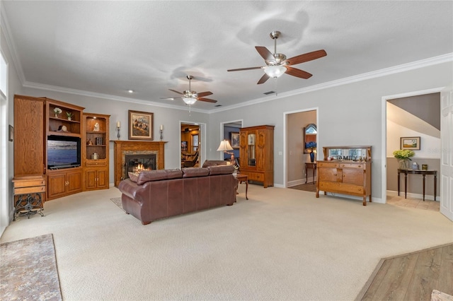 living room with light carpet, ornamental molding, and ceiling fan