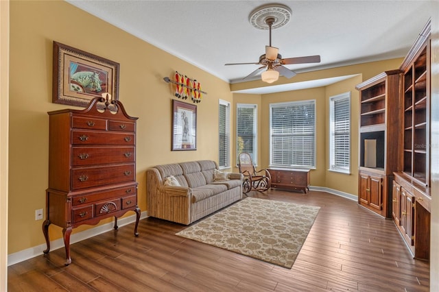 sitting room featuring dark hardwood / wood-style floors and ceiling fan