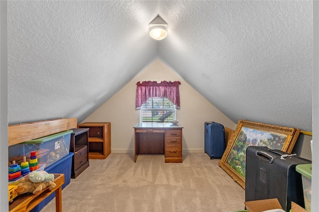 interior space featuring vaulted ceiling, light colored carpet, and a textured ceiling