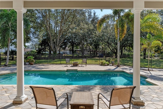 view of swimming pool with a patio area and an outdoor fire pit