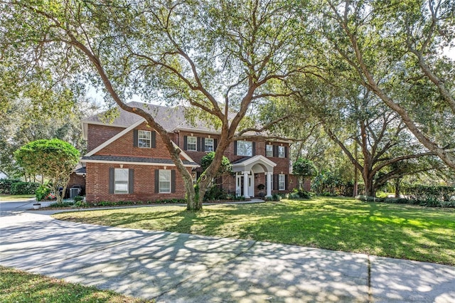 view of front of house featuring a front lawn and brick siding