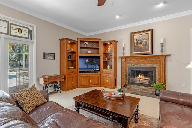 living room featuring ornamental molding, a high end fireplace, light carpet, and ceiling fan