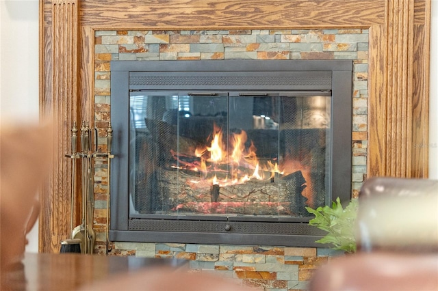 interior details with a glass covered fireplace