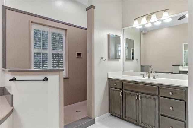 bathroom featuring vanity, a tile shower, and tile patterned floors