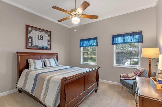 bedroom with light carpet, crown molding, multiple windows, and baseboards