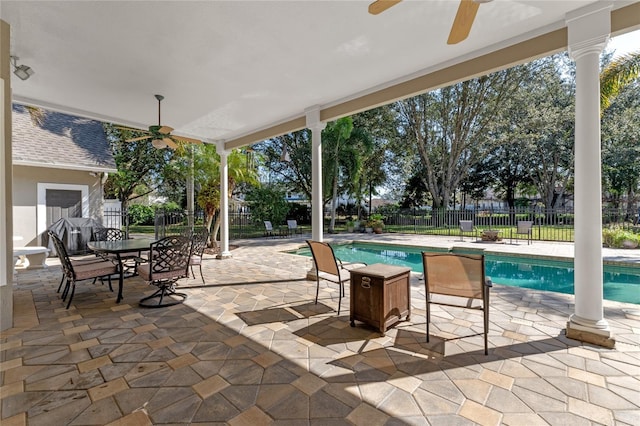 view of patio with ceiling fan, fence, and a fenced in pool