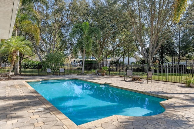 view of swimming pool with a fenced in pool, a patio, and fence