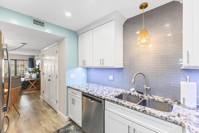 kitchen with decorative light fixtures, white cabinetry, decorative backsplash, and dishwasher