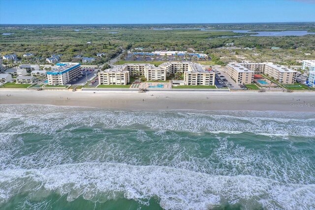 bird's eye view featuring a water view and a view of the beach