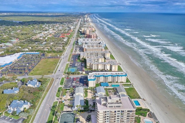 birds eye view of property with a water view and a view of the beach