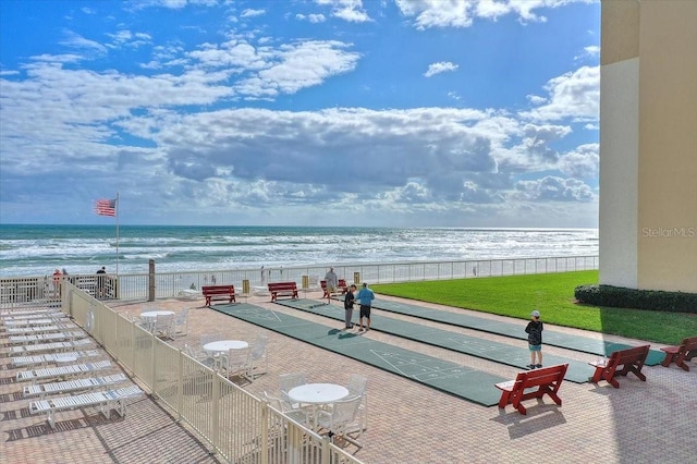 view of property's community featuring a water view and a view of the beach