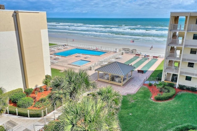 birds eye view of property featuring a water view and a view of the beach