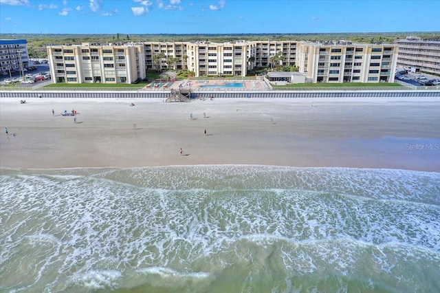 drone / aerial view featuring a water view and a beach view