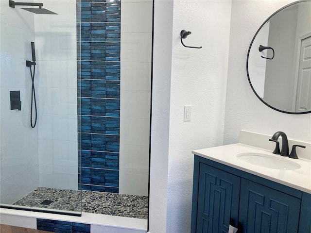 bathroom with vanity and a shower