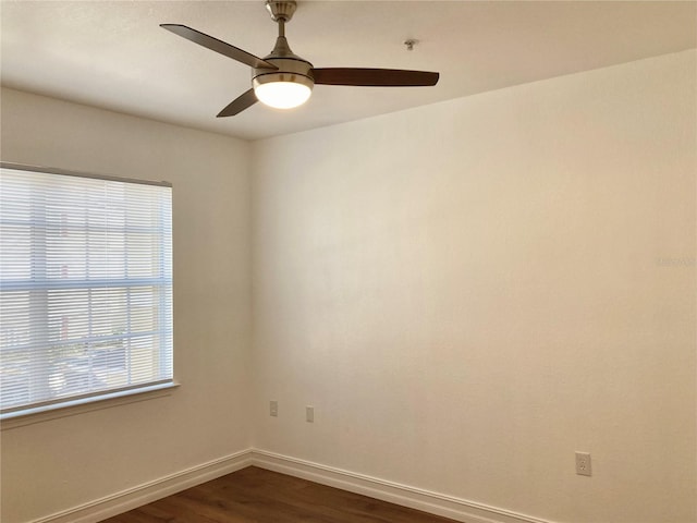 unfurnished room featuring ceiling fan and dark wood-type flooring