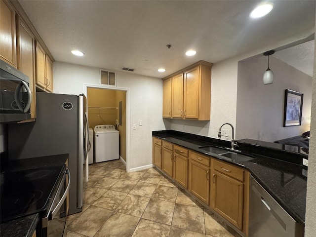 kitchen with sink, decorative light fixtures, dark stone countertops, and stainless steel appliances