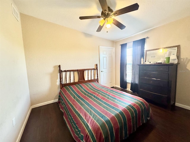 bedroom with ceiling fan and dark hardwood / wood-style flooring