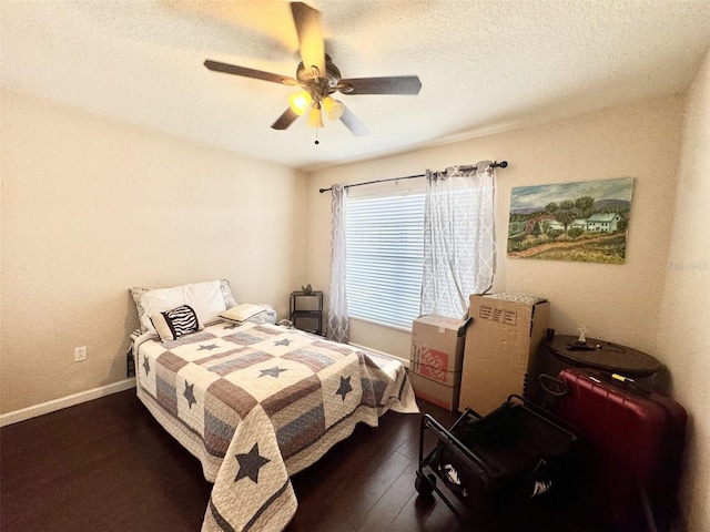 bedroom featuring ceiling fan, a textured ceiling, and dark hardwood / wood-style floors